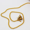 a gold beaded necklace with a bell on it