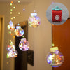a group of christmas ornaments hanging from a ceiling