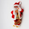 a santa clause doll hanging on a wall